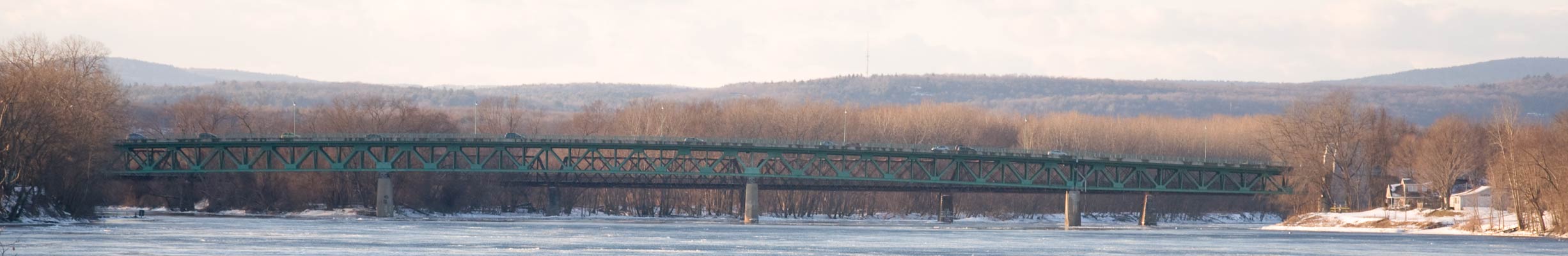 The Calvin Coolidge Bridge, with the Norwottuck Rail Trail Bridge behind it, over the Connecticut River in Northampton, Massachusetts